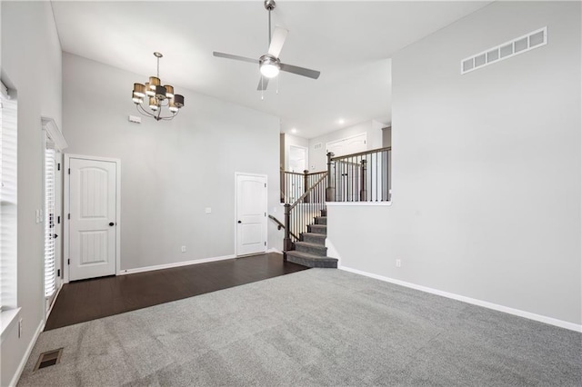 11704 N Laurel Ave, Kansas City, MO 64157 - unfurnished living room featuring carpet, a chandelier, stairway, a ceiling fan, and a high ceiling