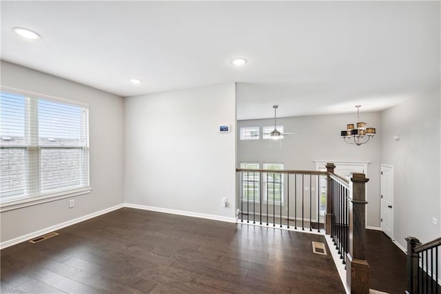 11704 N Laurel Ave, Kansas City, MO 64157 - spare room with plenty of natural light, wood finished floors, a chandelier, and recessed lighting