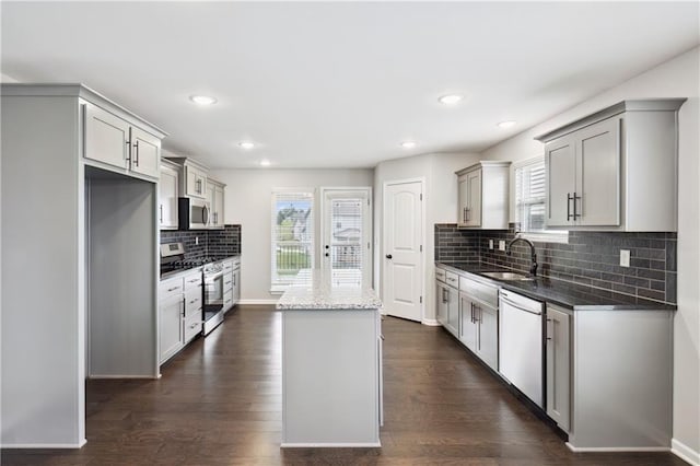 11704 N Laurel Ave, Kansas City, MO 64157 - kitchen with stainless steel appliances, a kitchen island, backsplash, healthy amount of natural light, and recessed lighting