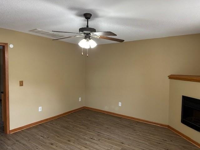 1002 NE Deer Creek Rd, Grain Valley, MO 64029 - unfurnished living room featuring ceiling fan, wood finished floors, and a fireplace