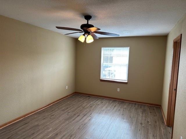 1002 NE Deer Creek Rd, Grain Valley, MO 64029 - unfurnished room featuring wood finished floors and a ceiling fan
