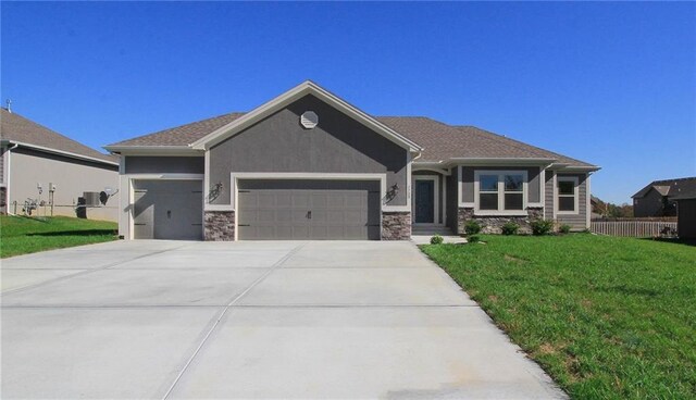 3718 NE 90th Ter, Kansas City, MO 64156 - view of front facade with a garage, stone siding, driveway, and stucco siding