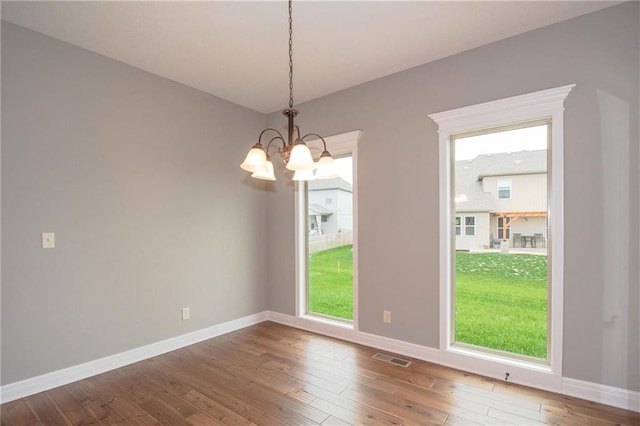 3718 NE 90th Ter, Kansas City, MO 64156 - unfurnished room with a chandelier and hardwood / wood-style flooring