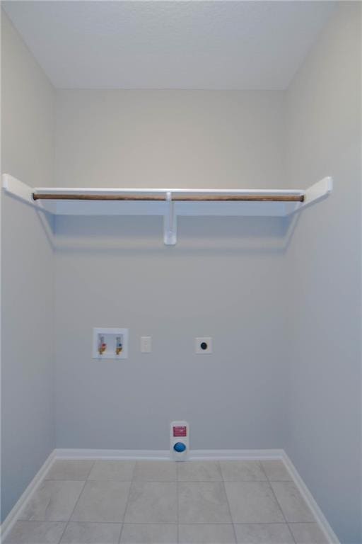 3718 NE 90th Ter, Kansas City, MO 64156 - laundry room with hookup for an electric dryer, hookup for a washing machine, and light tile patterned floors