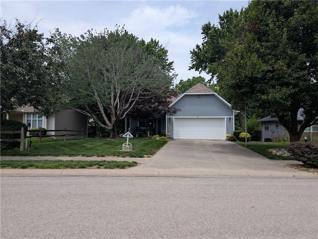 413 Quail Trl, Warrensburg, MO 64093 - obstructed view of property featuring driveway and an attached garage