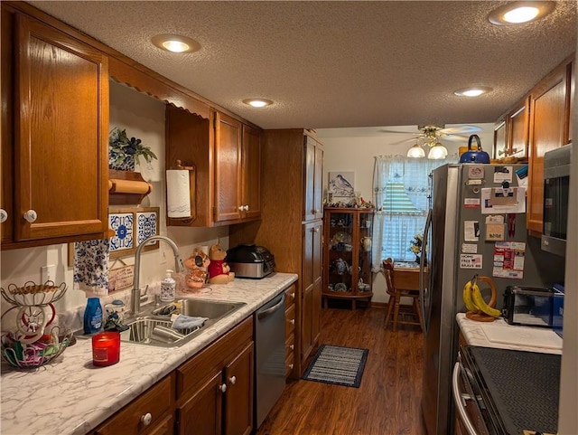 413 Quail Trl, Warrensburg, MO 64093 - kitchen with dishwasher, brown cabinets, light countertops, a textured ceiling, and dark wood-style floors