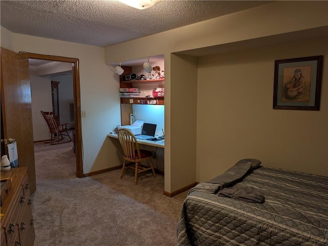 413 Quail Trl, Warrensburg, MO 64093 - bedroom with carpet, a textured ceiling, and an office area