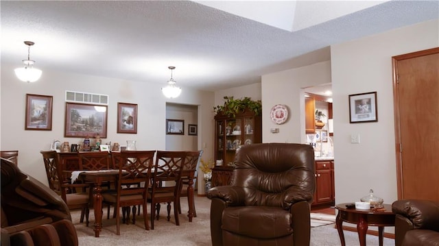 413 Quail Trl, Warrensburg, MO 64093 - dining space with light colored carpet, a skylight, and a textured ceiling
