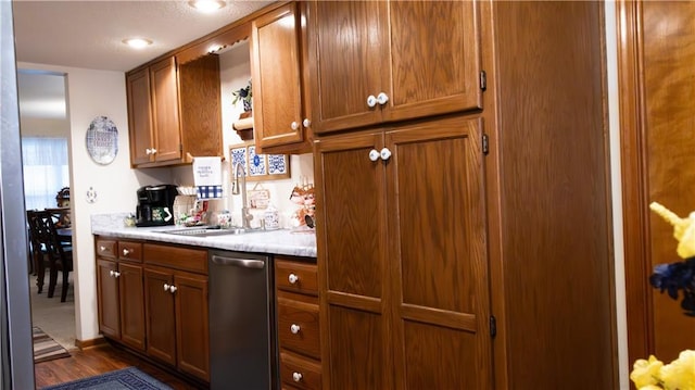 413 Quail Trl, Warrensburg, MO 64093 - kitchen featuring stainless steel dishwasher, brown cabinetry, light countertops, and dark wood-type flooring