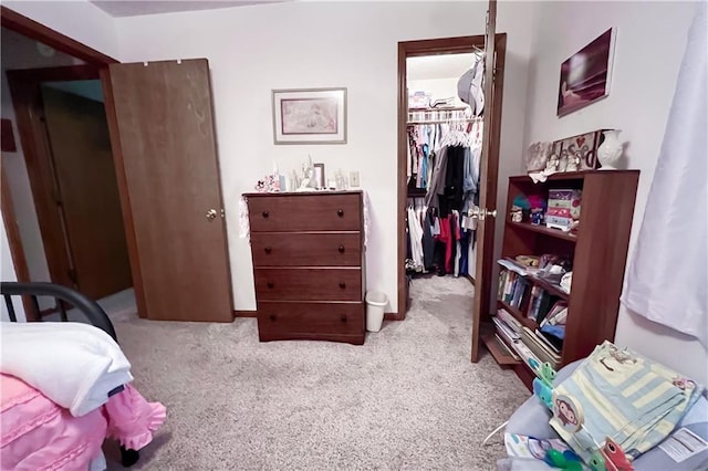 413 Quail Trl, Warrensburg, MO 64093 - bedroom with a spacious closet, a closet, and carpet flooring