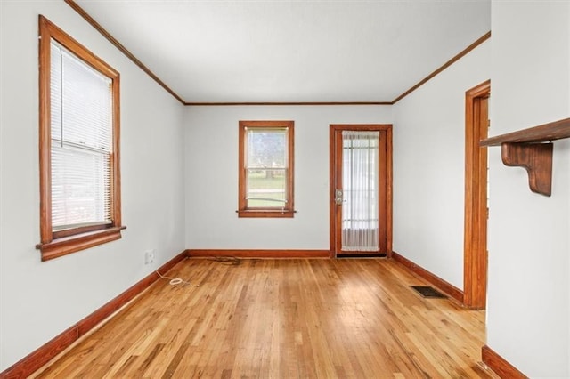 414 Dickinson Rd, Independence, MO 64050 - unfurnished room with ornamental molding and light wood-style flooring