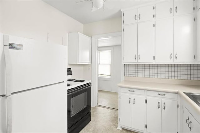 414 Dickinson Rd, Independence, MO 64050 - kitchen with freestanding refrigerator, electric range, and white cabinetry