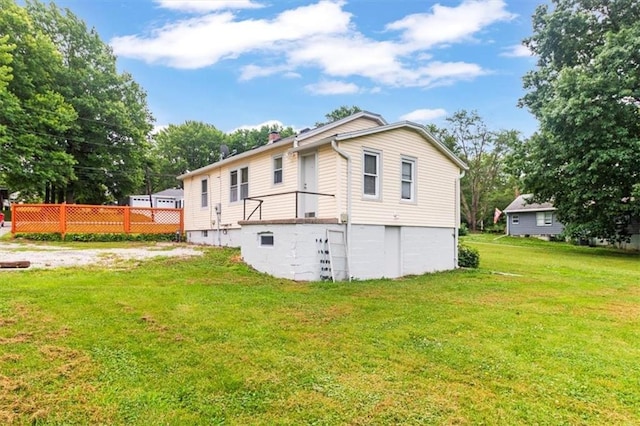414 Dickinson Rd, Independence, MO 64050 - back of house with a chimney and a lawn