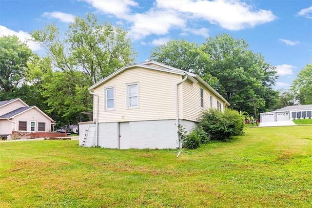 414 Dickinson Rd, Independence, MO 64050 - view of property exterior with a lawn and a detached garage