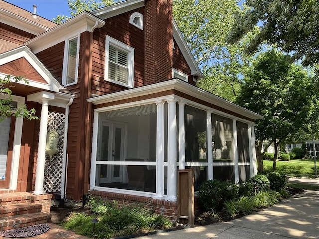 207 W 66th St, Kansas City, MO 64113 - view of property exterior featuring a sunroom and a chimney