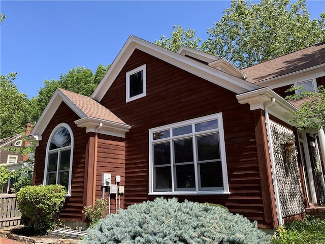207 W 66th St, Kansas City, MO 64113 - view of side of property with roof with shingles