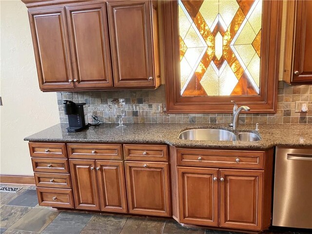 207 W 66th St, Kansas City, MO 64113 - kitchen featuring dishwasher, decorative backsplash, dark stone counters, brown cabinets, and dark stone finish floors