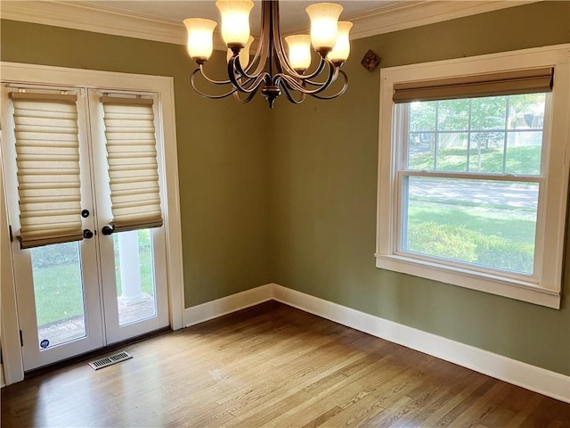 207 W 66th St, Kansas City, MO 64113 - unfurnished dining area with ornamental molding, a chandelier, wood finished floors, french doors, and plenty of natural light
