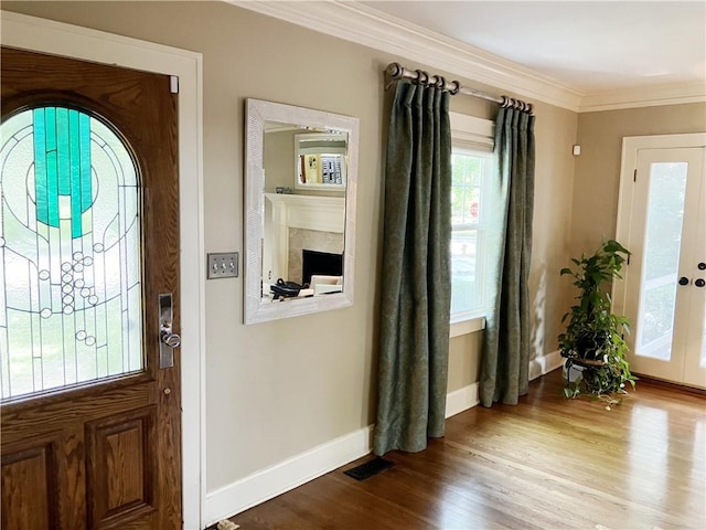 207 W 66th St, Kansas City, MO 64113 - entrance foyer featuring crown molding and wood finished floors