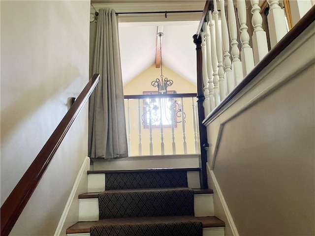 207 W 66th St, Kansas City, MO 64113 - stairs with a chandelier and baseboards