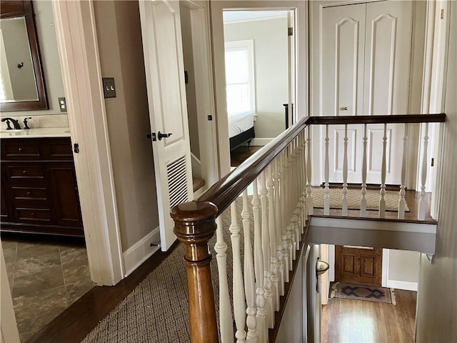 207 W 66th St, Kansas City, MO 64113 - stairs featuring baseboards and wood finished floors