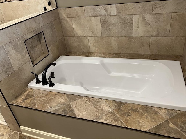 207 W 66th St, Kansas City, MO 64113 - bathroom featuring a garden tub and tile walls