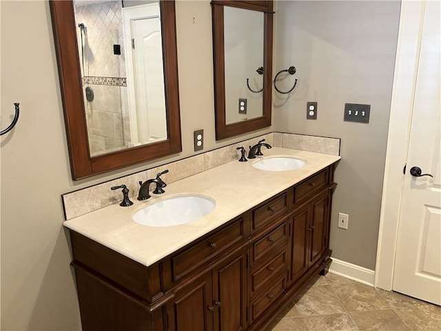 207 W 66th St, Kansas City, MO 64113 - bathroom featuring double vanity and baseboards