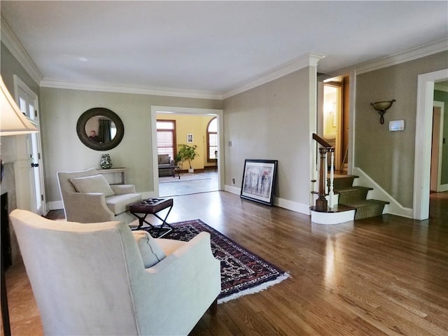 207 W 66th St, Kansas City, MO 64113 - living room with wood finished floors, stairway, a fireplace, and crown molding