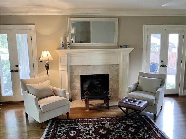 207 W 66th St, Kansas City, MO 64113 - living area with french doors, dark wood-style flooring, crown molding, and a tile fireplace