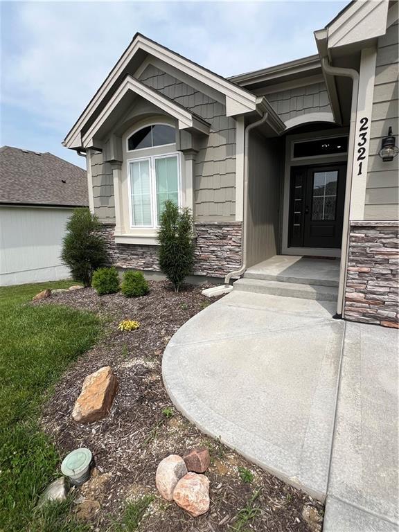 2321 Dovecott Dr, Kearney, MO 64060 - property entrance featuring stone siding