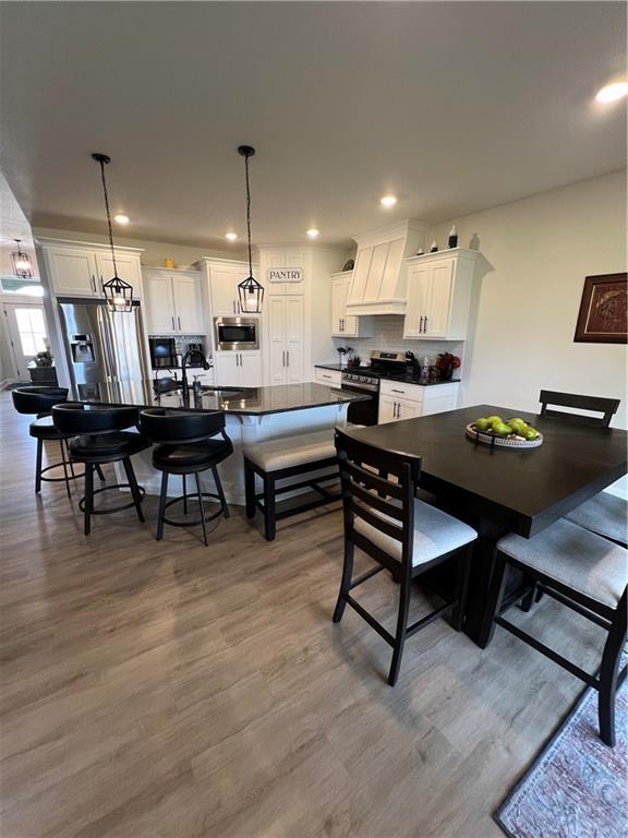 2321 Dovecott Dr, Kearney, MO 64060 - dining area with wood finished floors and recessed lighting