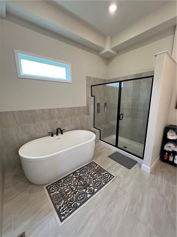 2321 Dovecott Dr, Kearney, MO 64060 - bathroom with tile walls, a soaking tub, and a stall shower
