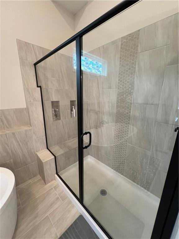 2321 Dovecott Dr, Kearney, MO 64060 - bathroom with a stall shower, tile walls, and tile patterned floors