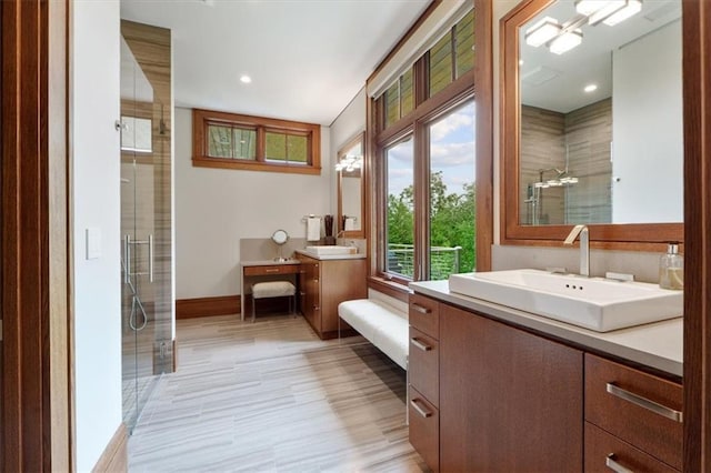 2720 Verona Cir, Mission Hills, KS 66208 - bathroom with tiled shower, two vanities, wood finished floors, and recessed lighting