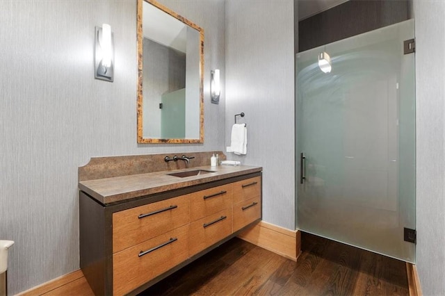 2720 Verona Cir, Mission Hills, KS 66208 - bathroom with wood finished floors, vanity, and a shower