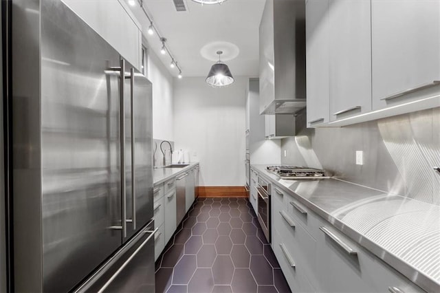 2720 Verona Cir, Mission Hills, KS 66208 - kitchen with stainless steel appliances, stainless steel countertops, wall chimney range hood, and modern cabinets