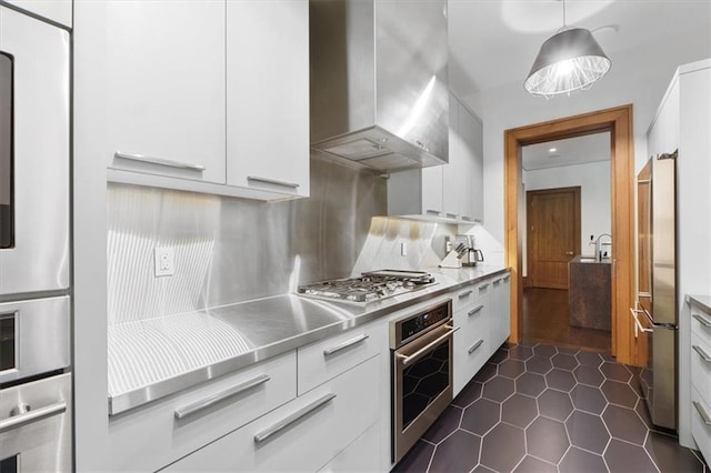 2720 Verona Cir, Mission Hills, KS 66208 - kitchen featuring stainless steel countertops, appliances with stainless steel finishes, wall chimney exhaust hood, and modern cabinets