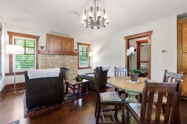 2720 Verona Cir, Mission Hills, KS 66208 - dining room featuring dark wood finished floors, a chandelier, and a stone fireplace
