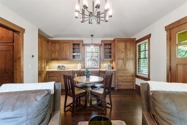 2720 Verona Cir, Mission Hills, KS 66208 - dining space featuring a chandelier, dark wood finished floors, and lofted ceiling