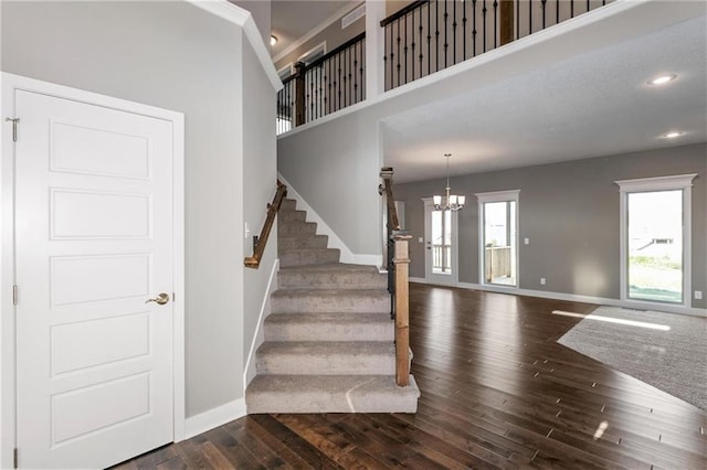 3726 NE 90th Ter, Kansas City, MO 64156 - staircase featuring hardwood / wood-style flooring, recessed lighting, a chandelier, and a towering ceiling