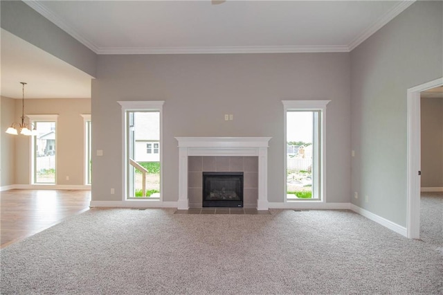 8911 N Monroe Ave, Kansas City, MO 64156 - unfurnished living room with carpet floors, a chandelier, healthy amount of natural light, and ornamental molding