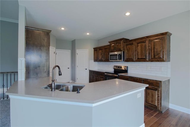 8911 N Monroe Ave, Kansas City, MO 64156 - kitchen with electric range, stainless steel microwave, backsplash, dark brown cabinets, and recessed lighting