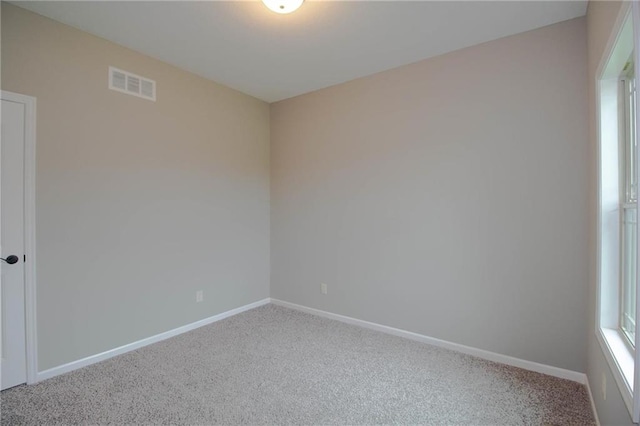 8911 N Monroe Ave, Kansas City, MO 64156 - carpeted spare room with baseboards