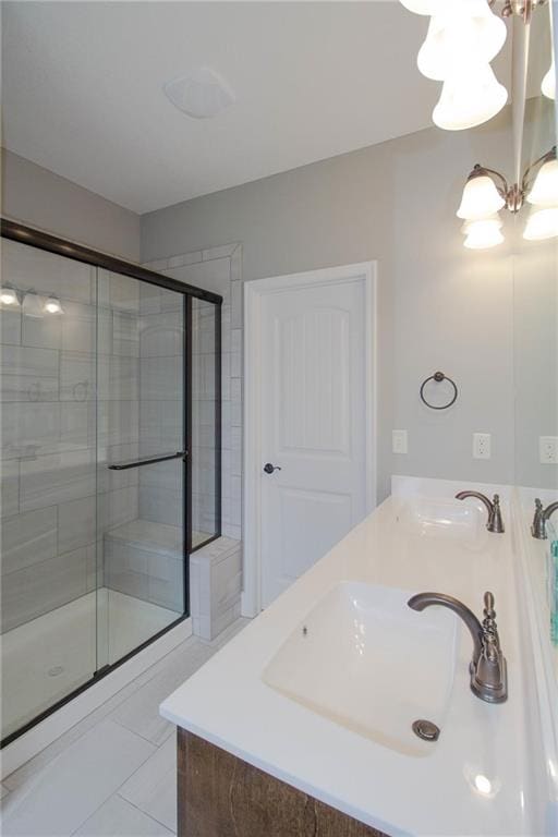 8911 N Monroe Ave, Kansas City, MO 64156 - bathroom featuring a stall shower, double vanity, a chandelier, and tile patterned floors