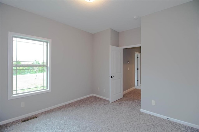 8911 N Monroe Ave, Kansas City, MO 64156 - carpeted empty room featuring healthy amount of natural light