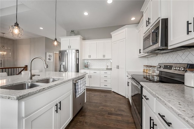 14168 Nicollete Ct, Basehor, KS 66007 - kitchen with appliances with stainless steel finishes, a center island with sink, tasteful backsplash, white cabinetry, and dark wood finished floors