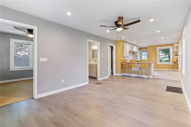 3640 Cleveland Ave, Kansas City, MO 64128 - unfurnished living room featuring ceiling fan, light wood finished floors, and recessed lighting