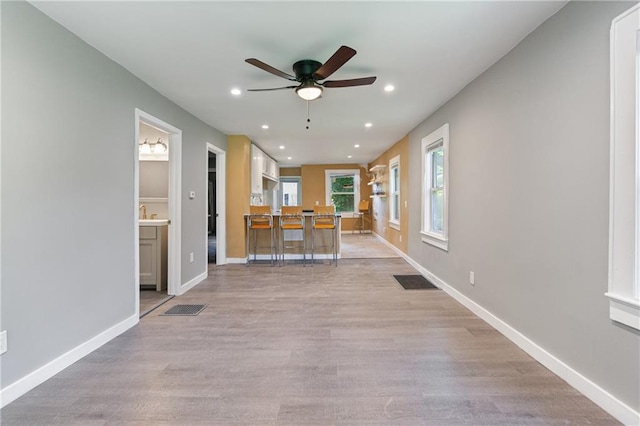 3640 Cleveland Ave, Kansas City, MO 64128 - unfurnished living room with a ceiling fan, recessed lighting, and light wood-type flooring