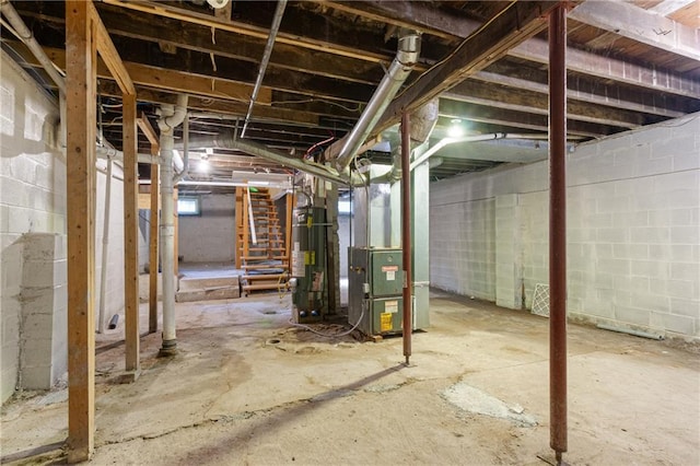 3640 Cleveland Ave, Kansas City, MO 64128 - unfinished basement with gas water heater, heating unit, and stairs