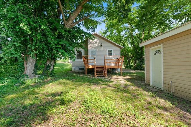 3640 Cleveland Ave, Kansas City, MO 64128 - view of green lawn featuring a deck and an outdoor structure